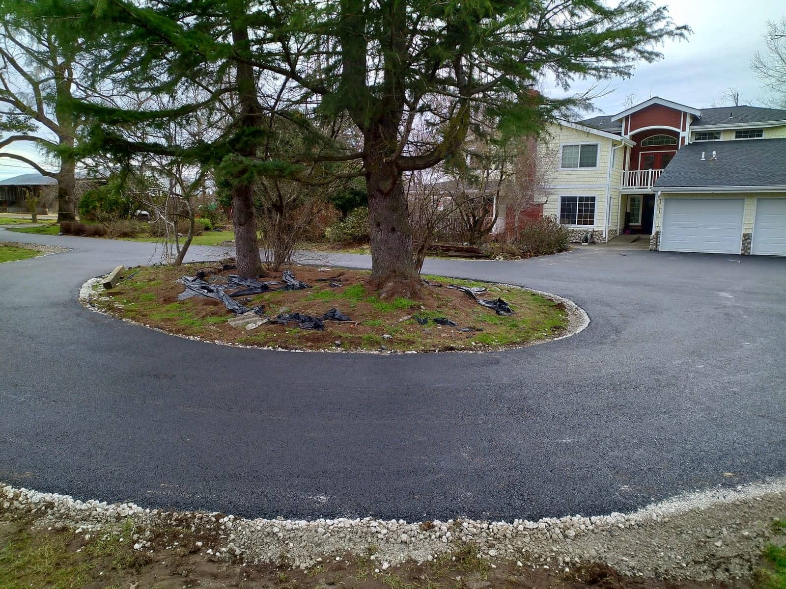 Circular driveway paved around a landscaped island