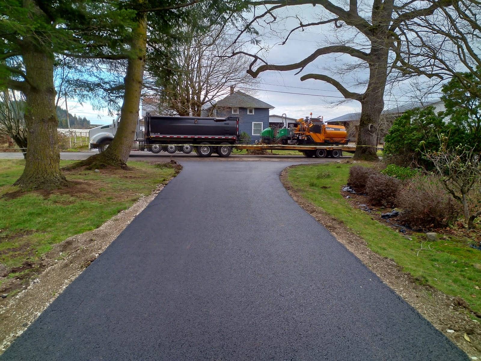 Crisp new asphalt lane running between lawns