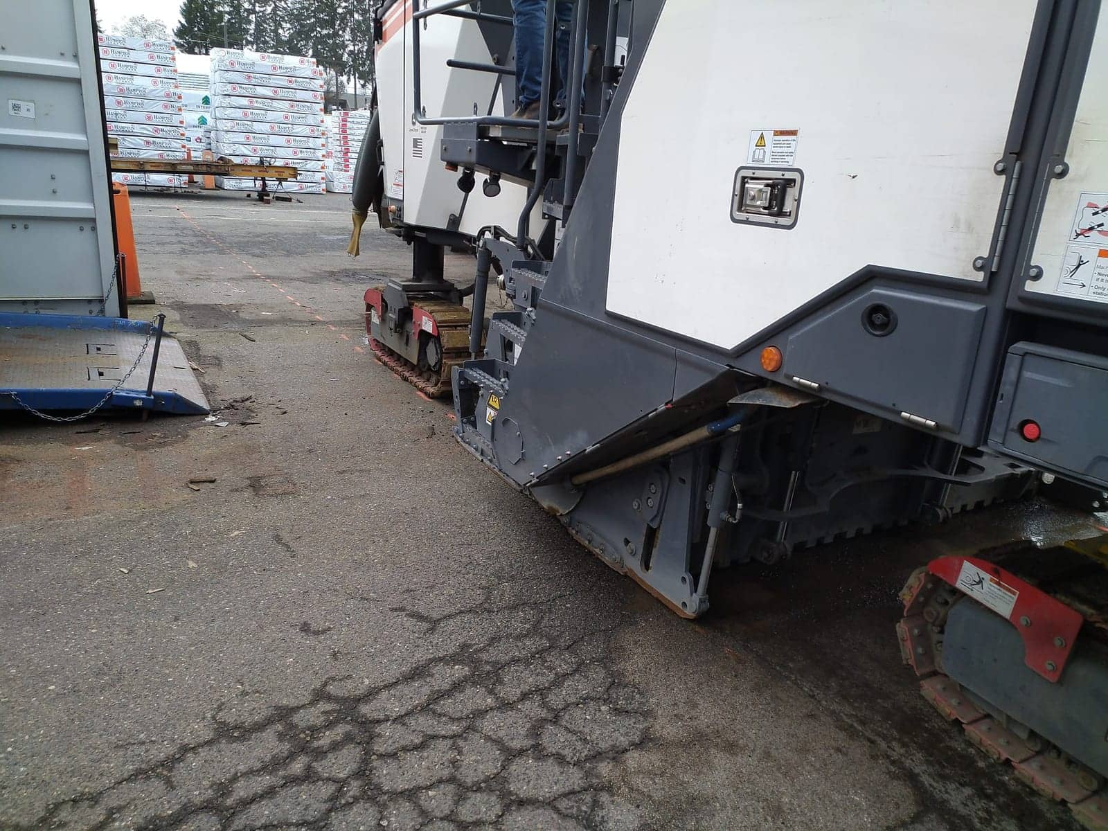 Milling machine removing cracked asphalt before repaving