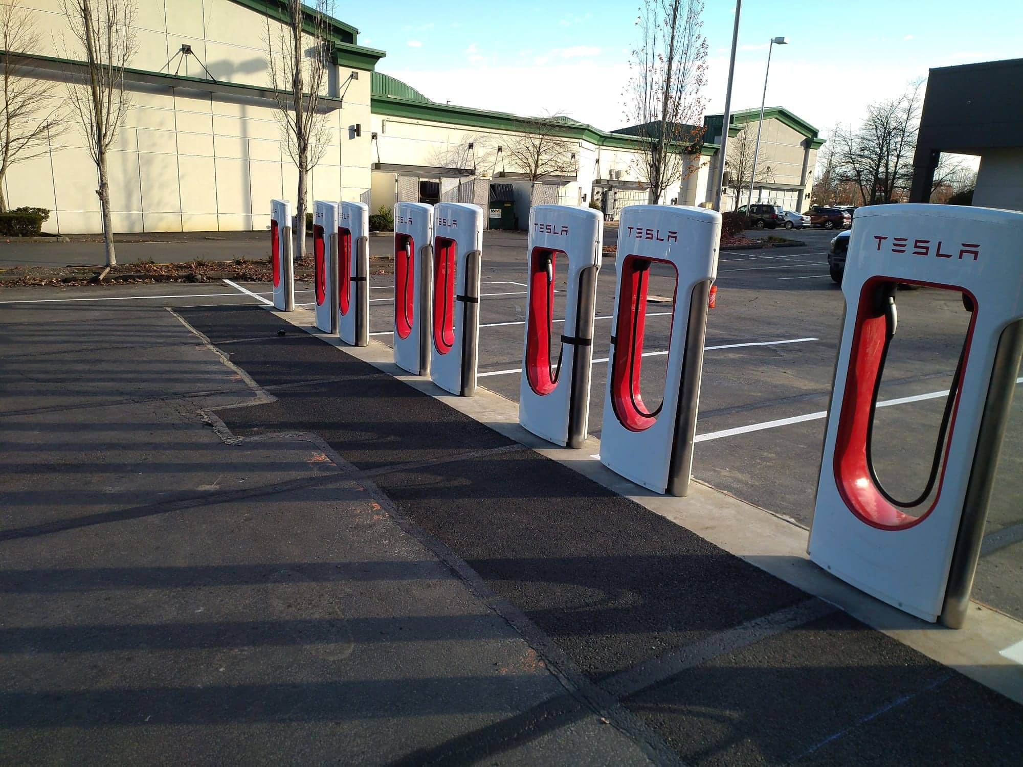 Fresh asphalt paving at a commercial electric-vehicle charging site