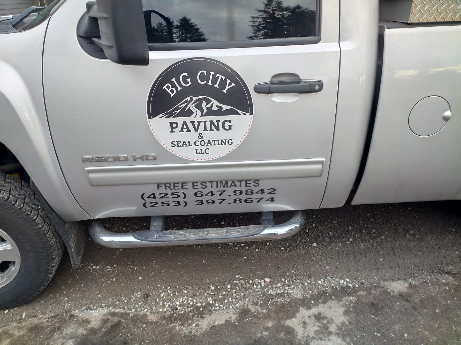 Big City Paving & Seal Coating truck door with the company badge