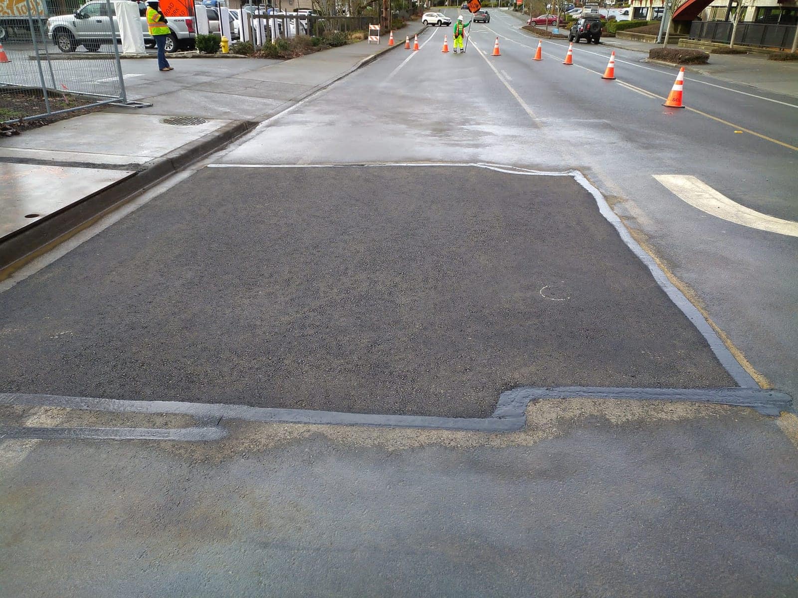 Completed asphalt street repair with tack-sealed edges